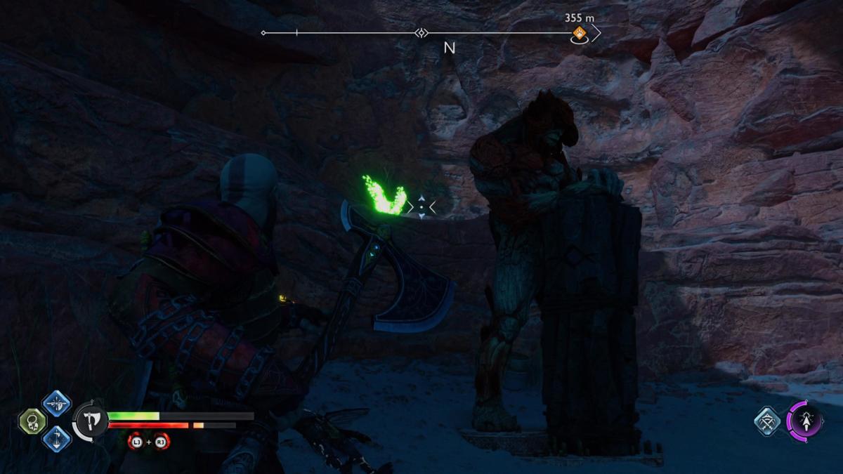 A raven hides behind a sleeping troll in God of War Ragnarok.